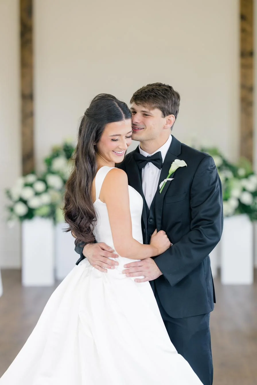A couple inside the chapel with florals at the altar