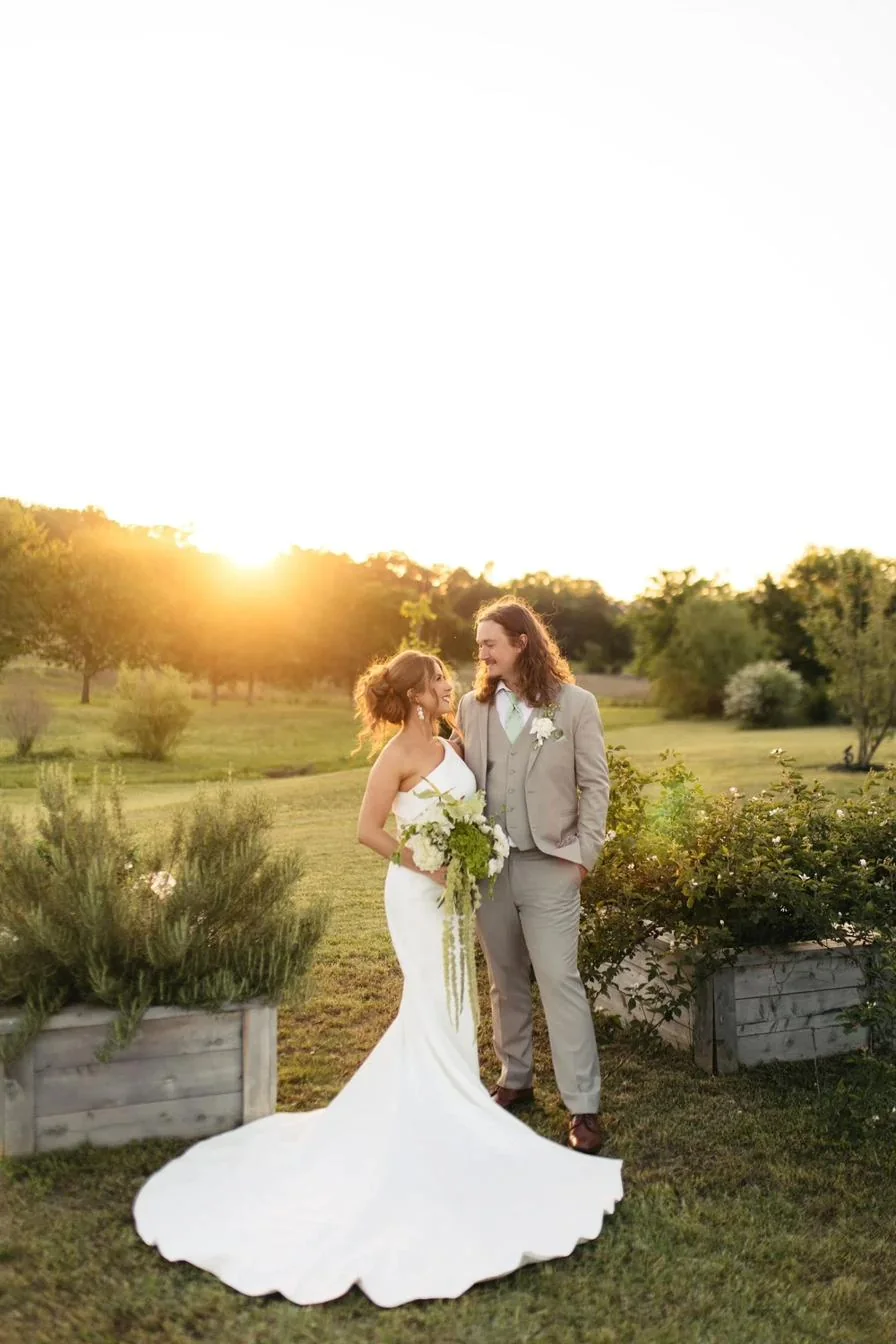 A couple in the gardens at sunset at Gateley Hill Gardens