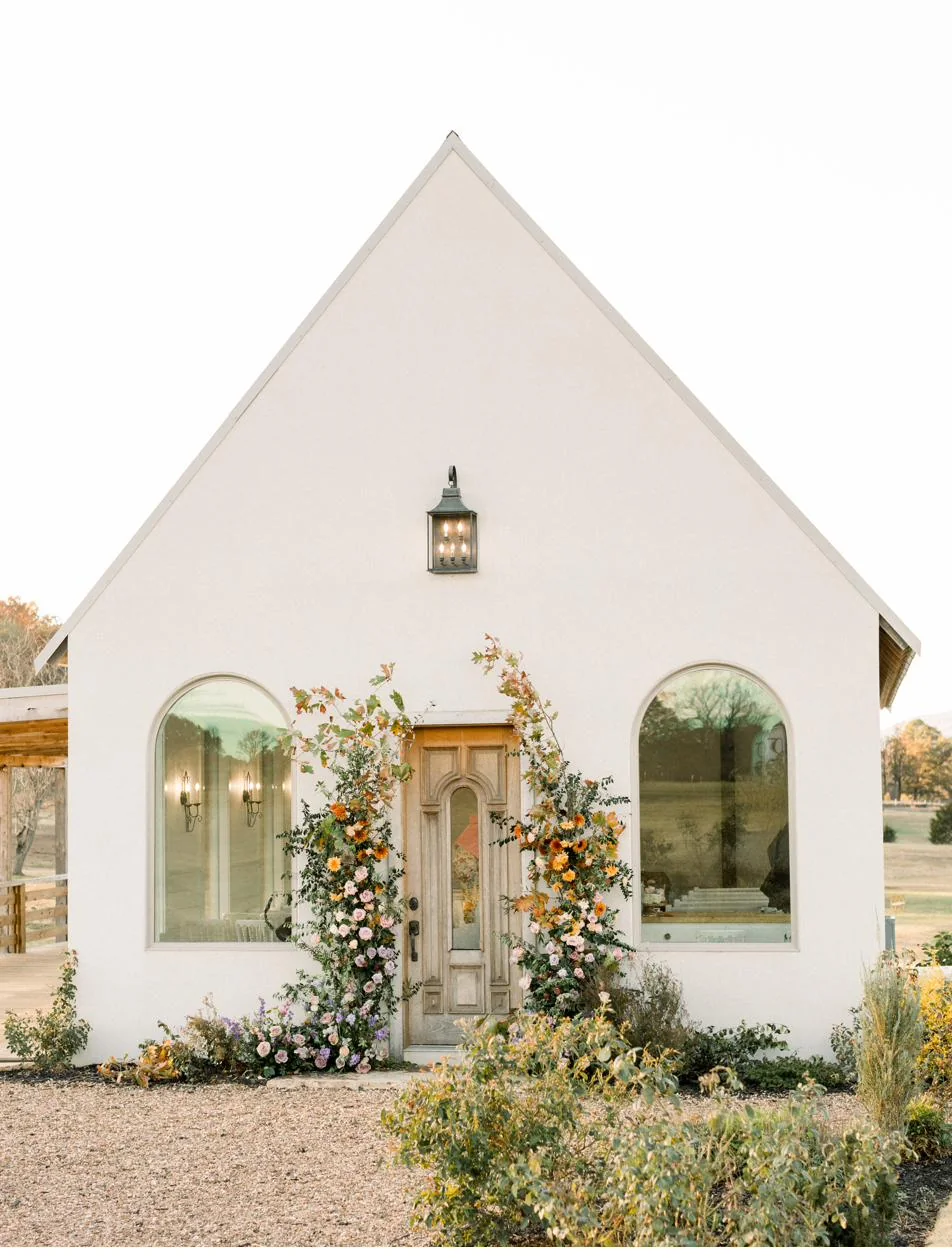 The chapel doorway with a fresh floral installation at Gateley Hill Gardens